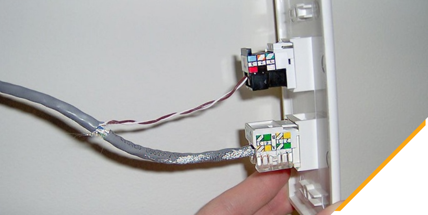 An electrician installing a phoneline connection